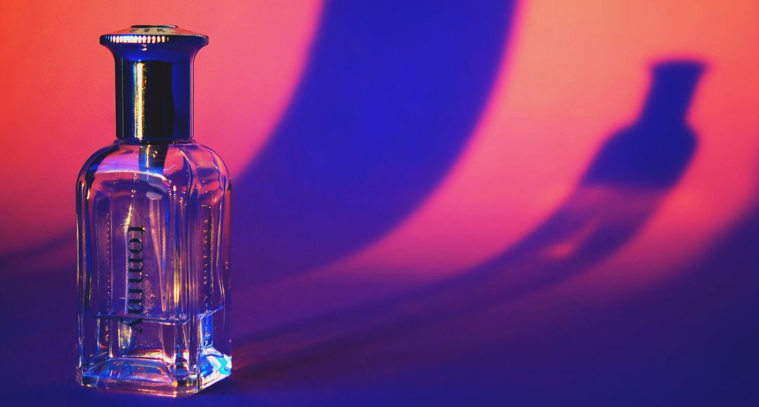 Image of a perfume and a pink and purple background - Ten powerful advertising techniques to lure customers and boost your sales - Image