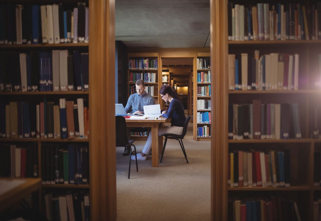 Image of two people studying on a table in the library - Topics and ideas for blogs that will inspire you and keep your readers engaged - Image