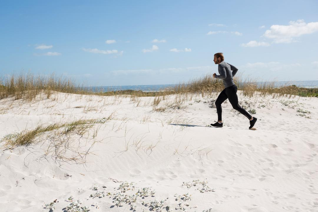 Image of a man running in sports clothes at the beach - Topics and ideas for blogs that will inspire you and keep your readers engaged - Image