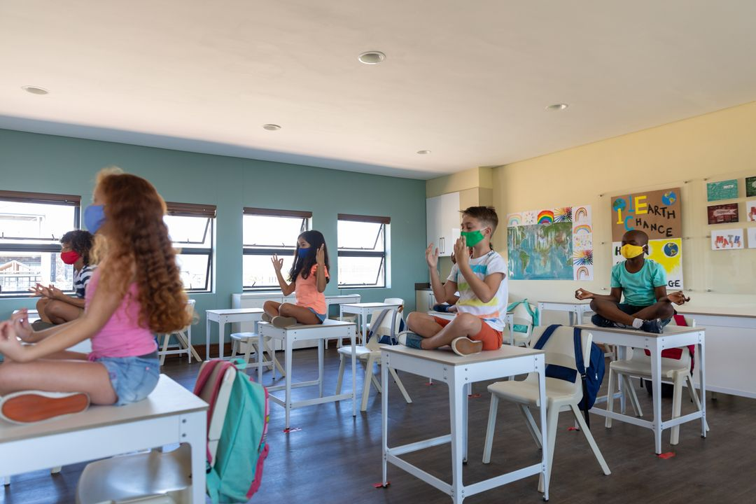 Image of a classroom with children sitting on the table and doing yoga - Topics and ideas for blogs that will inspire you and keep your readers engaged - Image