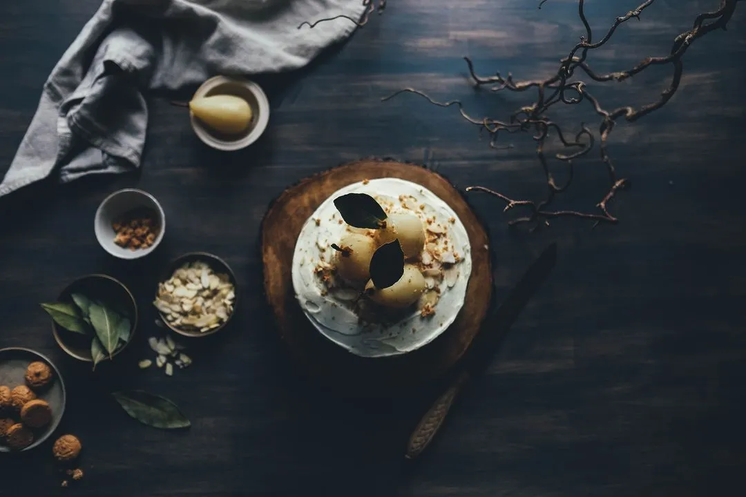 Image of plates of food laid out on a dark wooden table - The concept and application of the 'hero image' in web design - Image