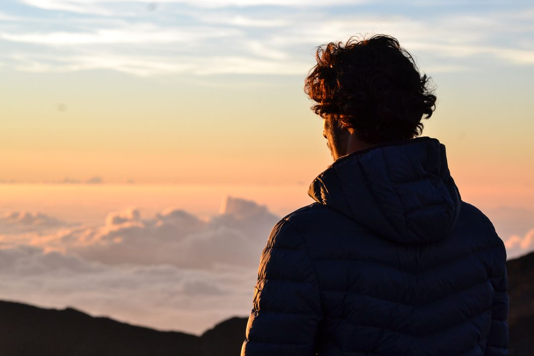 Image of a Man Looking out from Mountain Top at Sunrise