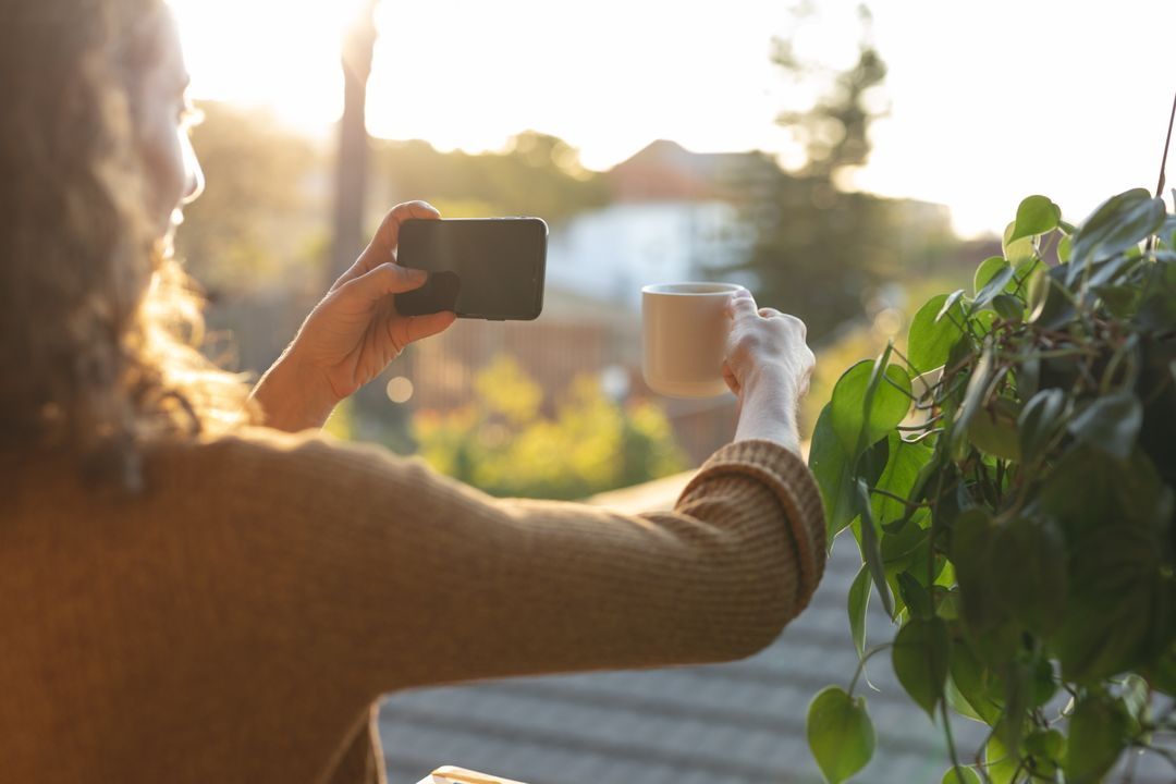 Image of a woman taking a picture with her smartphone of her morning coffee on the balcony - The beginner's guide to YouTube marketing, how to increase subscribers quickly - Image