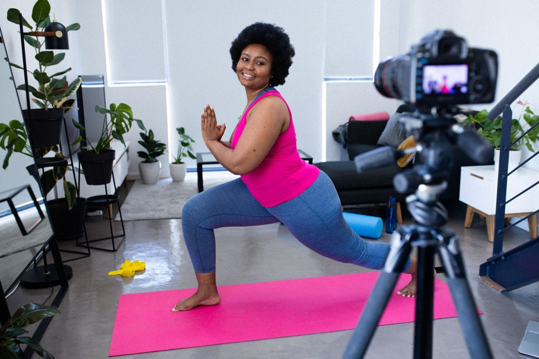 Image of a woman recording herself with a camera on a tripod doing yoga - The beginner's guide to YouTube marketing, how to increase subscribers quickly - Image