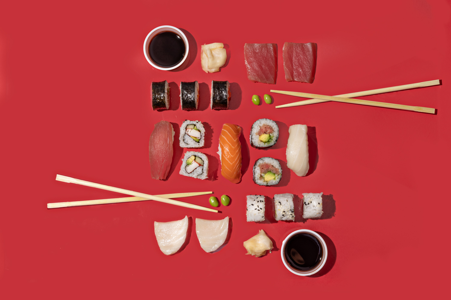 Sushi and chopsticks on a red background - There is no clear winner between minimalism and maximalism - Image