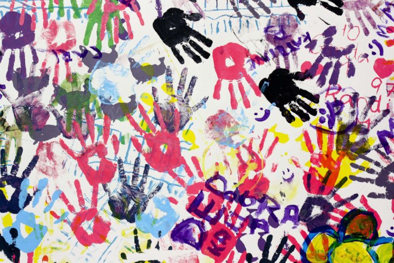 Colorful handprints on a wall - Comparing the influence of minimalist and maximalist aesthetics on the design industry - Image