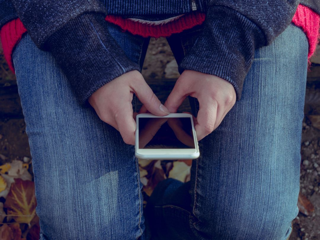Image of a Woman with a Smartphone in her Hands