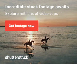 This is a photo of two horses in the water. The horses are at the beach, with one standing in the shallow water and the other partially submerged. They appear to be outdoors, and the image has a text watermark.