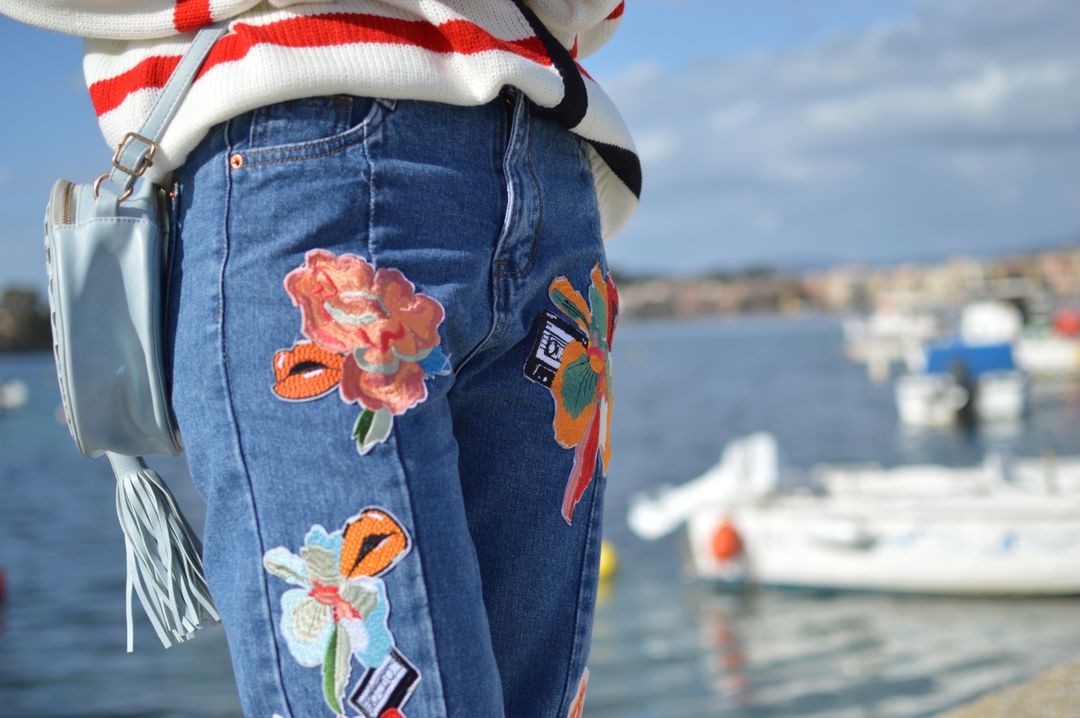 Woman standing with colourful embroidered jeans - Everything you need to know about stock photos - Image