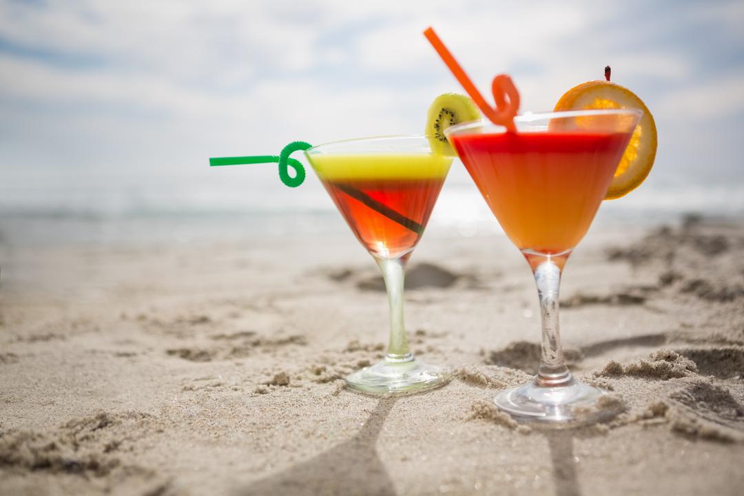 Two glasses of cocktail drink kept on sand - Free Images, Stock Photos and Pictures on Pikwizard.com