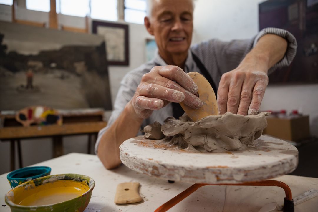 Man crumples piece of white clay for sculpting Stock Photo