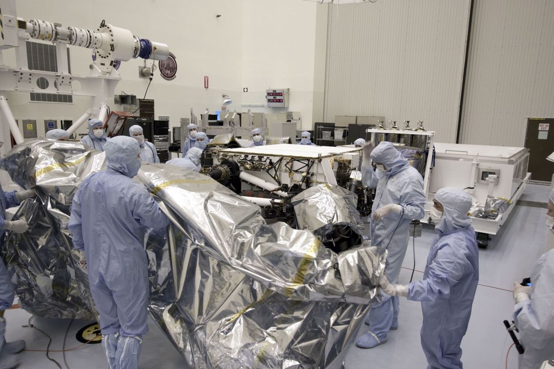 a group of people working on a space craft - Free Images, Stock Photos and Pictures on Pikwizard.com