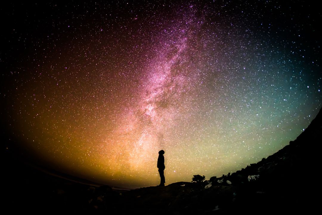 a person standing in front of a milky way - Free Images, Stock Photos and Pictures on Pikwizard.com