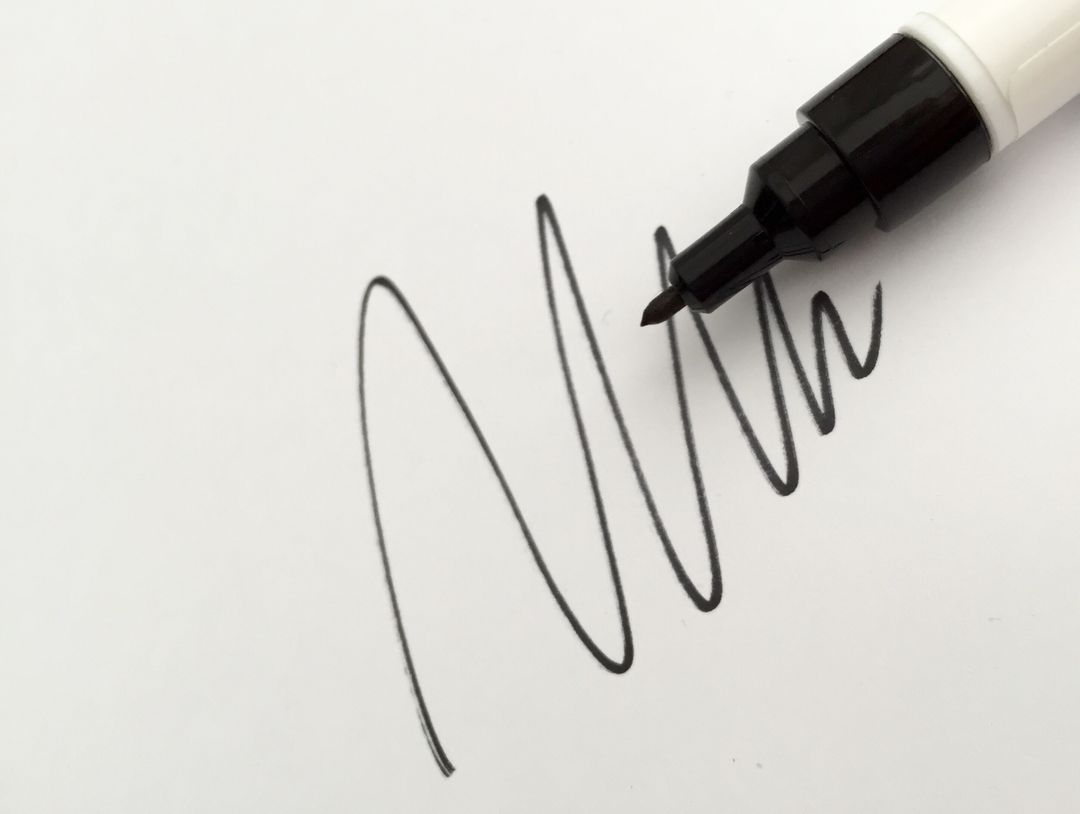 a pen writing on a piece of paper - Free Images, Stock Photos and Pictures on Pikwizard.com