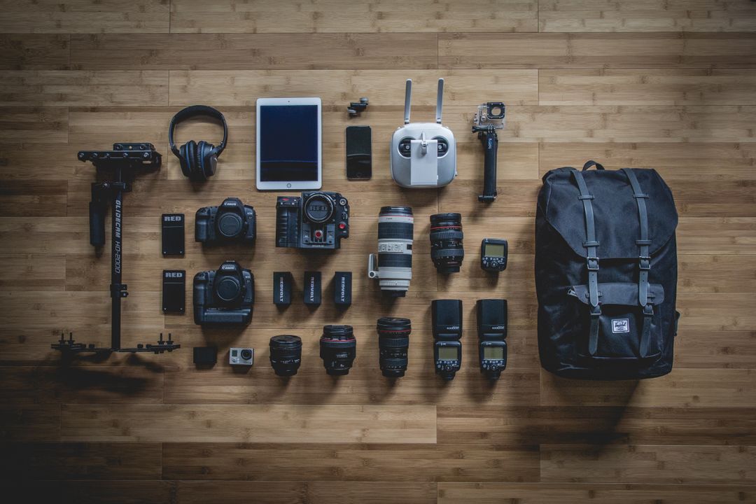 Overhead image of a selection of cameras and photography equipment, comparing the technology