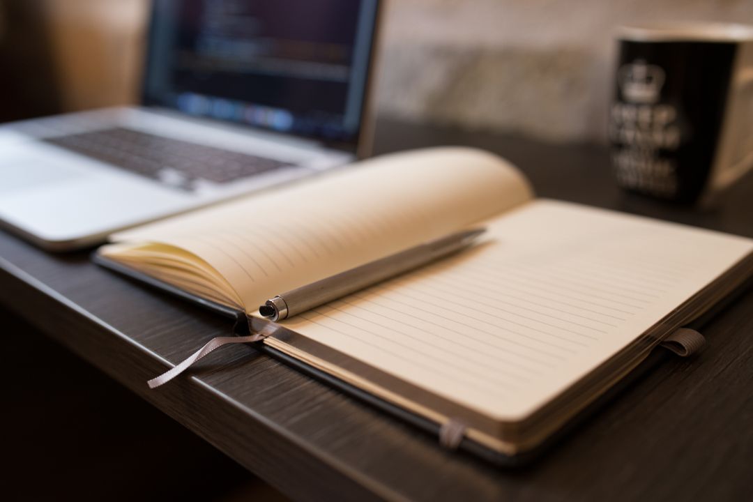 Image of a Notebook with a Pen on a Desk 