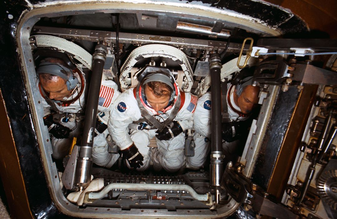 three astronauts inside of a space capsule - Free Images, Stock Photos and Pictures on Pikwizard.com