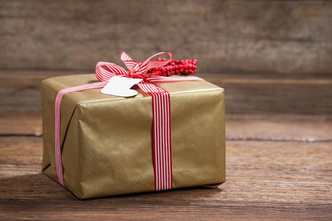 Gift wrapping. Wrapping paper, tape and gift box on a light wooden table.  Stock Photo by ©SashaMagic 442123744