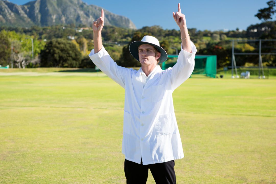 Full length of cricket umpire signalling out during match from Pikwizard