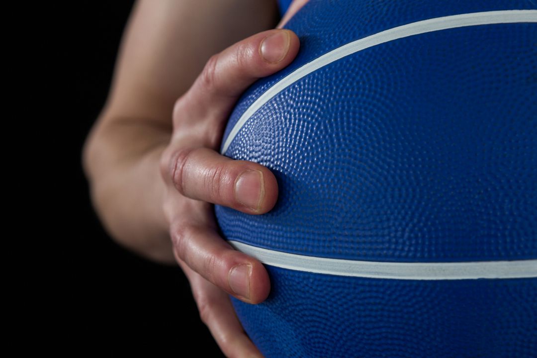 Mid section of player holding basketball - Free Images, Stock Photos and Pictures on Pikwizard.com
