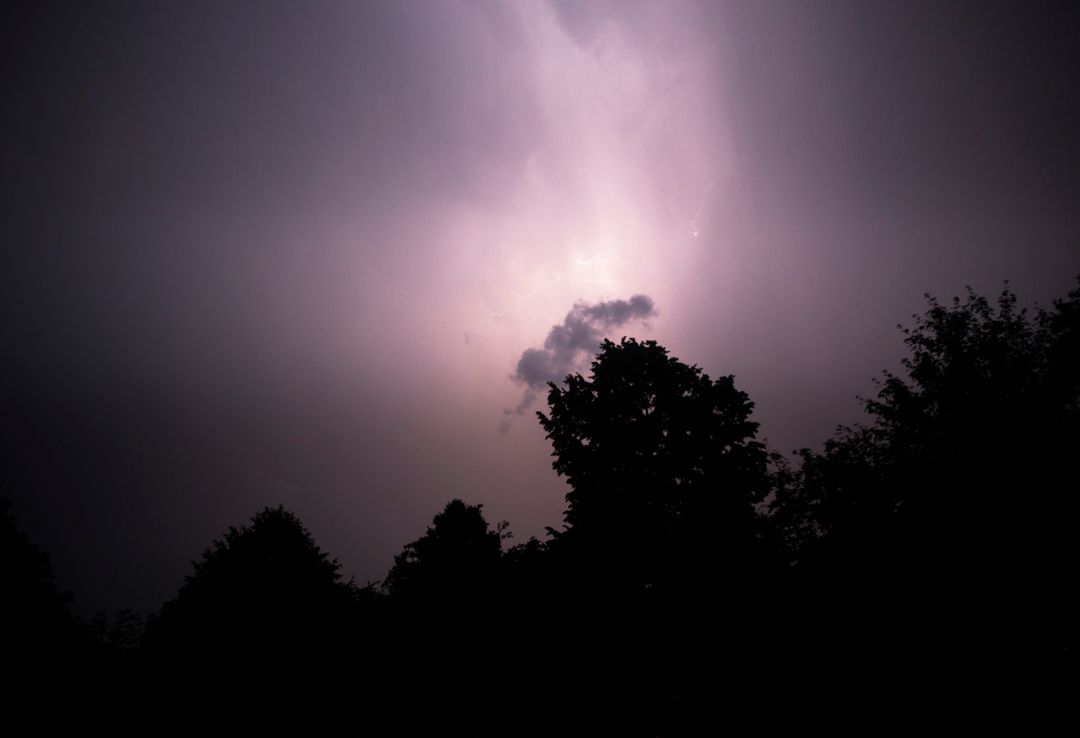 a lightning bolt over a dark sky - Free Images, Stock Photos and Pictures on Pikwizard.com