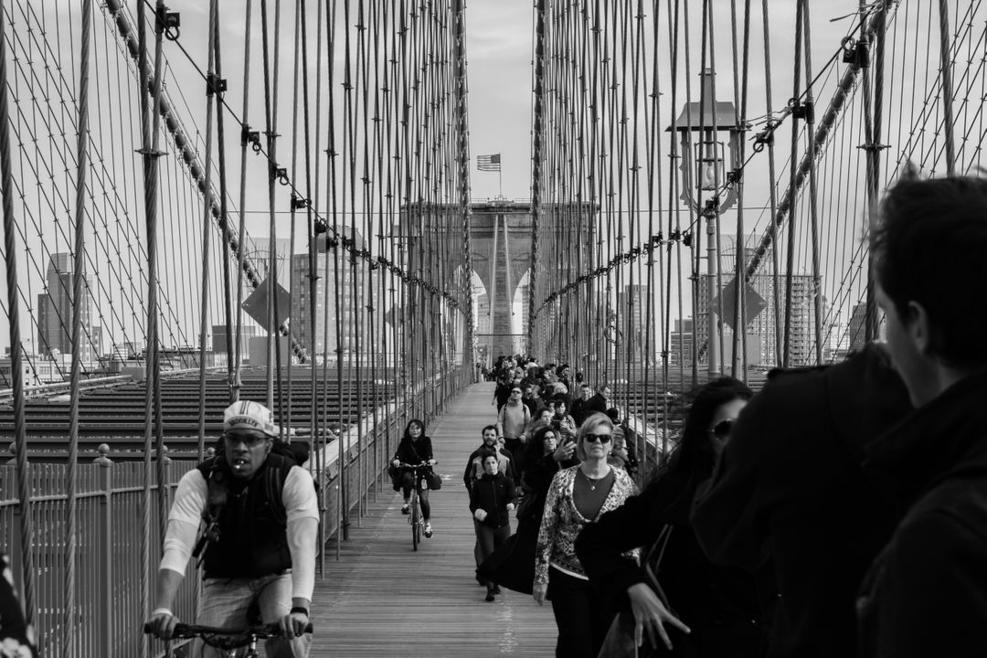Grayscale Photo of People Walking on a Bridge during Daytime - Free Images, Stock Photos and Pictures on Pikwizard.com