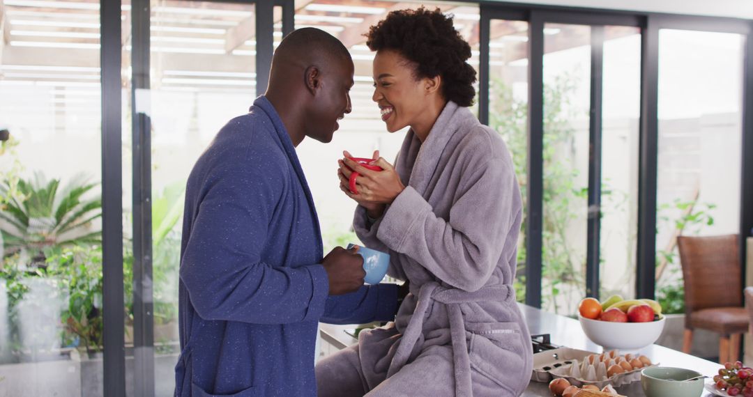 Image of happy african american couple drinking coffee together in kitchen - Free Images, Stock Photos and Pictures on Pikwizard.com
