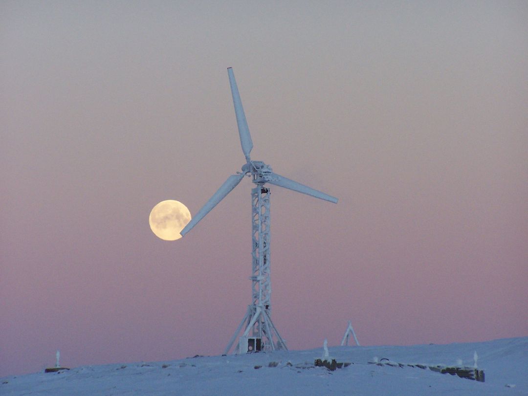 a wind turbine with a full moon - Free Images, Stock Photos and Pictures on Pikwizard.com