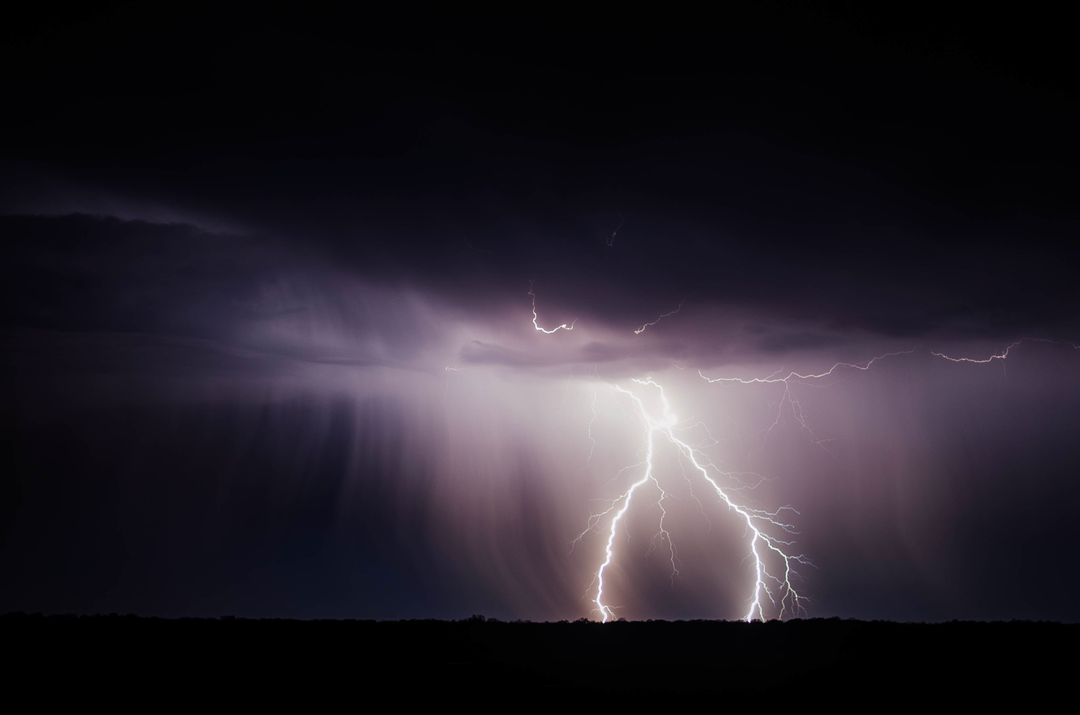 Image of the Sky at Night While Lightning Strikes