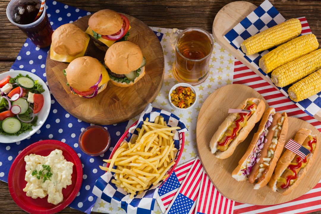 Hot dogs and burgers on wooden table with 4th july theme - Free Images, Stock Photos and Pictures on Pikwizard.com