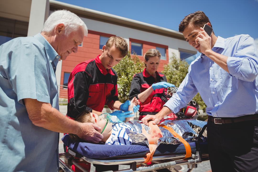 Paramedics examining injured boy - Free Images, Stock Photos and Pictures on Pikwizard.com
