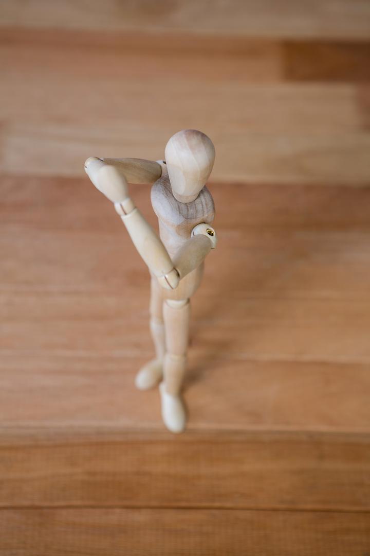 Figurine performing stretching exercise - Free Images, Stock Photos and Pictures on Pikwizard.com