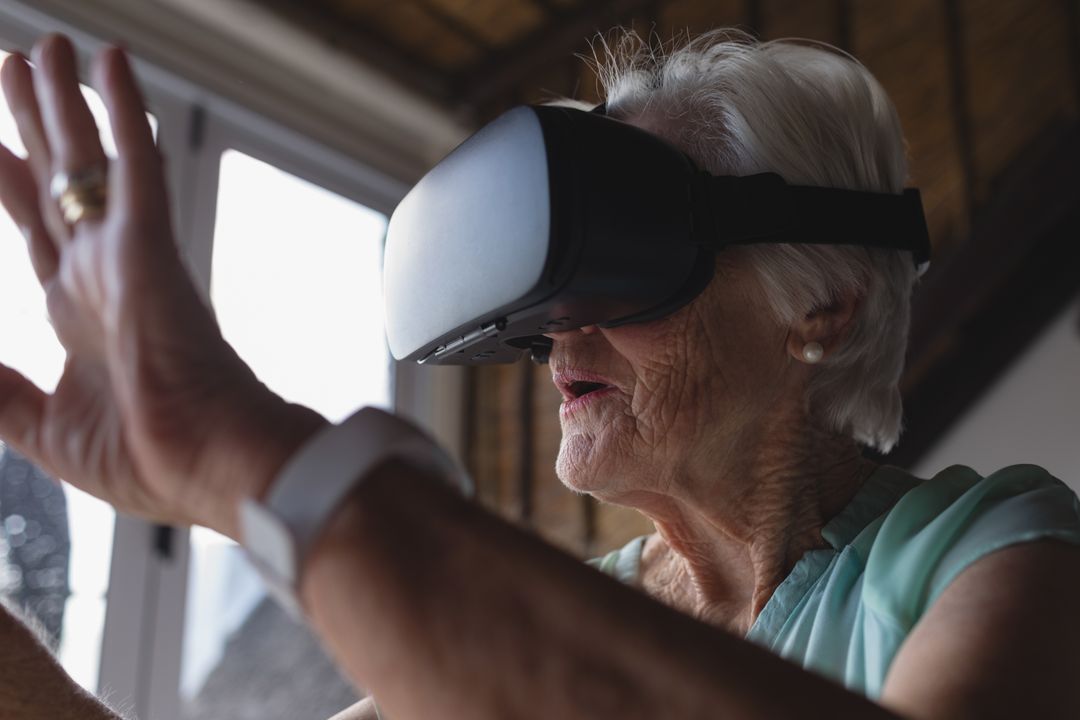 Senior woman using virtual reality headset - Free Images, Stock Photos and Pictures on Pikwizard.com