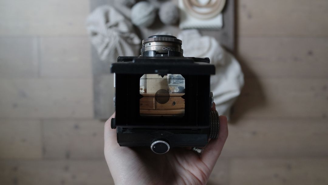 Image of a camera taking a picture of a product on a wooden surface