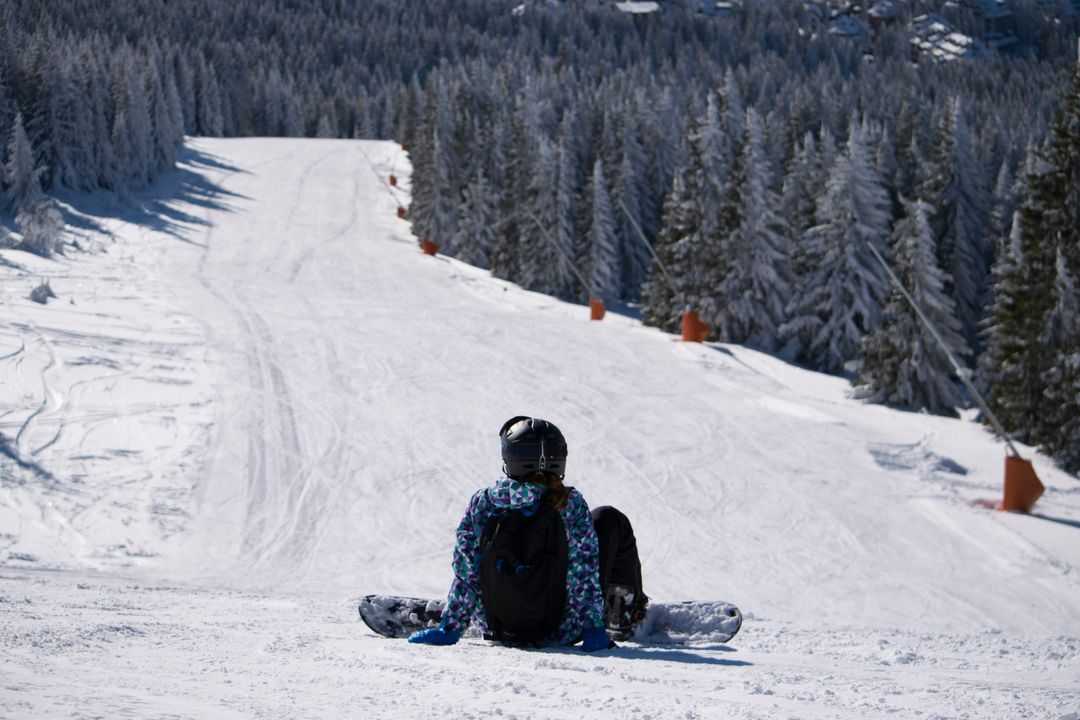 a person sitting on the snow - Free Images, Stock Photos and Pictures on Pikwizard.com