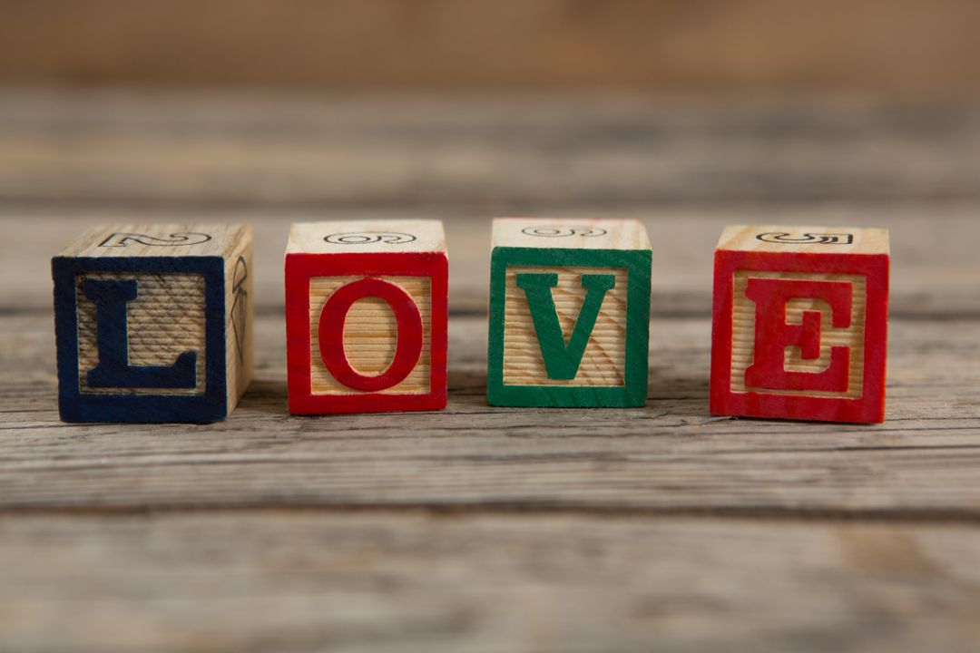 Blocks displaying love message on wooden surface
