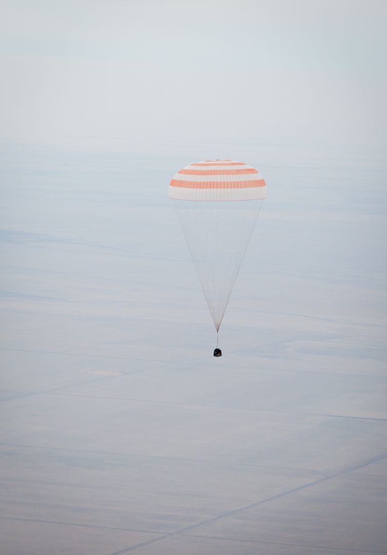 a parachute being used to land a spacecraft - Free Images, Stock Photos and Pictures on Pikwizard.com