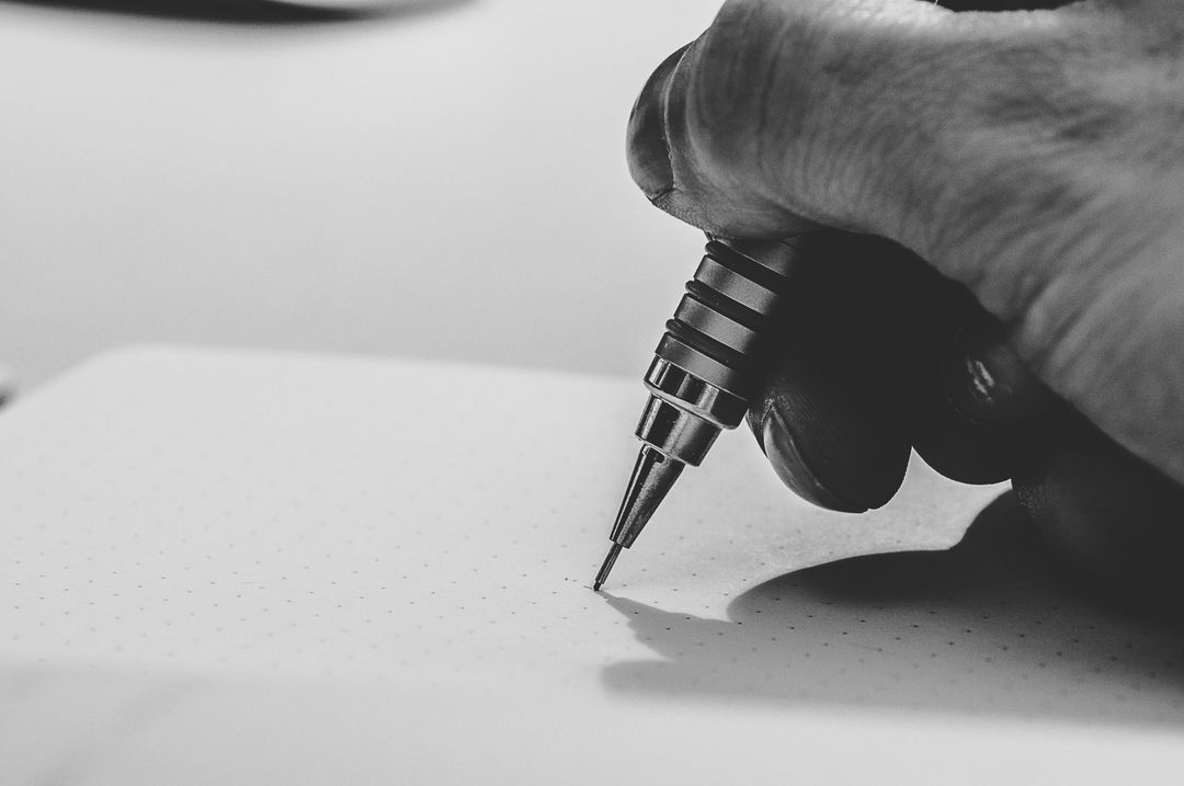 a person writing on a piece of paper - Free Images, Stock Photos and Pictures on Pikwizard.com