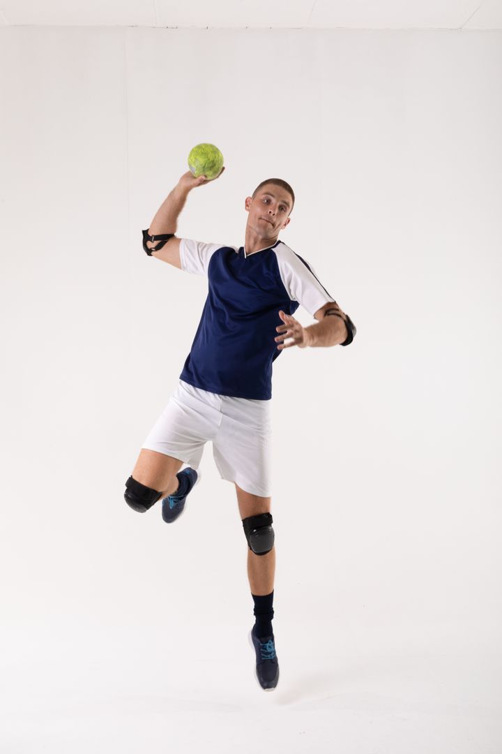 Full length of caucasian young male athlete throwing handball over white background with copy space - Free Images, Stock Photos and Pictures on Pikwizard.com