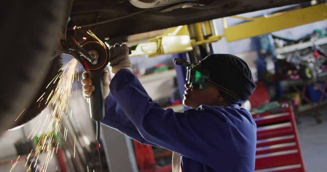 Image of african american female car mechanic using grinder - Free Images, Stock Photos and Pictures on Pikwizard.com