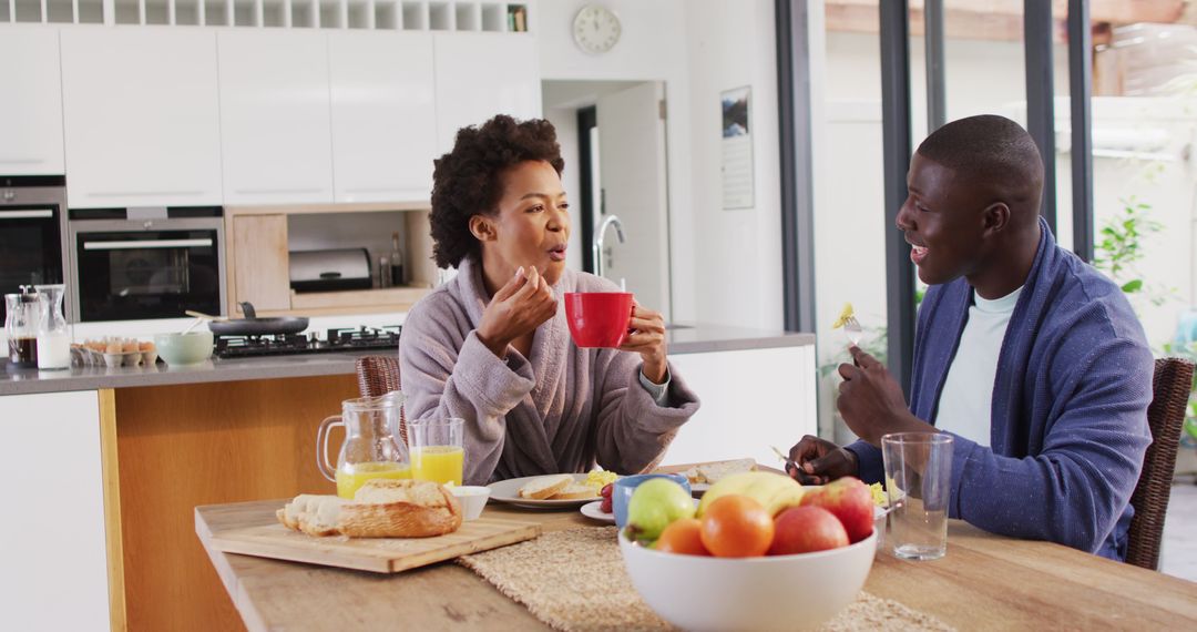 Image of happy african american couple eating breakfast together - Free Images, Stock Photos and Pictures on Pikwizard.com