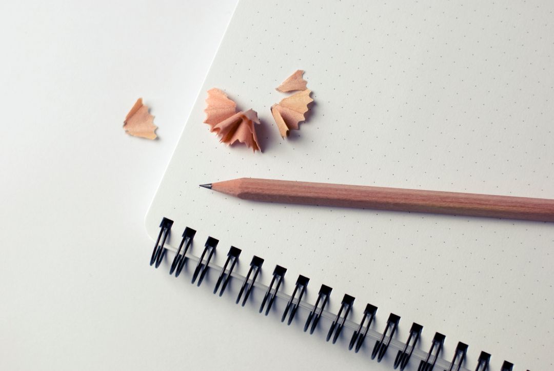 Image of a Sharpened Pencil on a Notebook