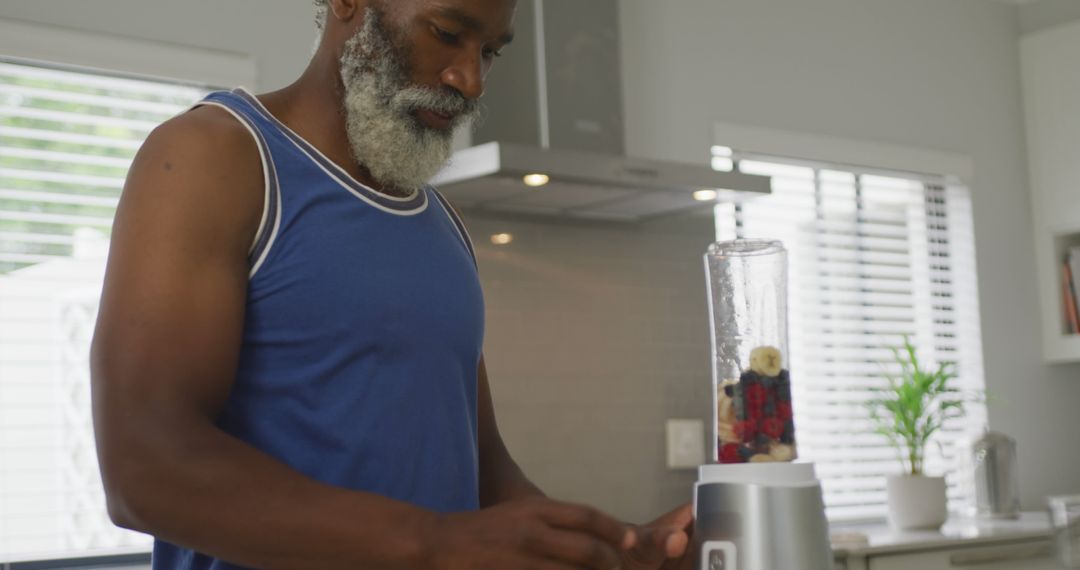 Image of african american senior man preparing smoothie - Free Images, Stock Photos and Pictures on Pikwizard.com