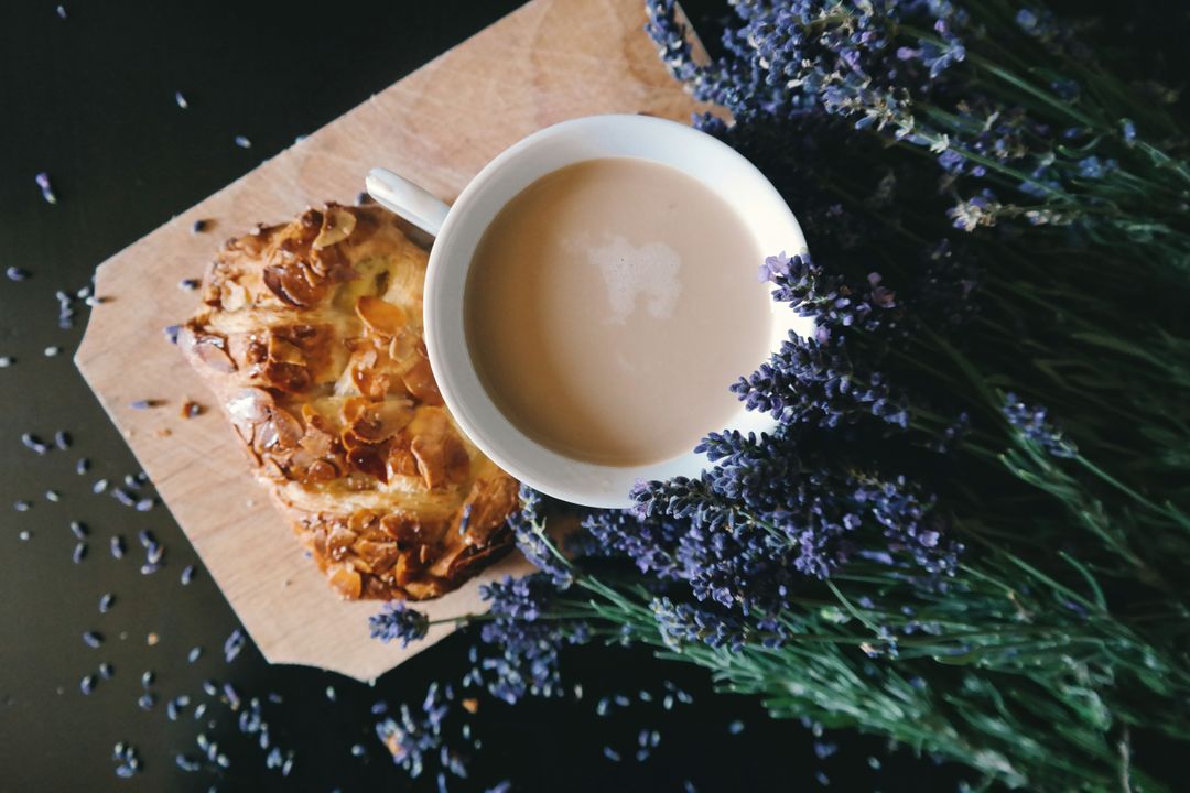 a cup of tea and a pastry on a wooden table with lavender flowers - Free Images, Stock Photos and Pictures on Pikwizard.com