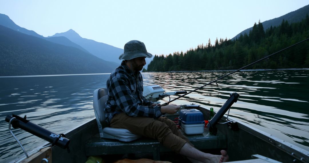 A young Caucasian man enjoys a peaceful fishing trip at a serene