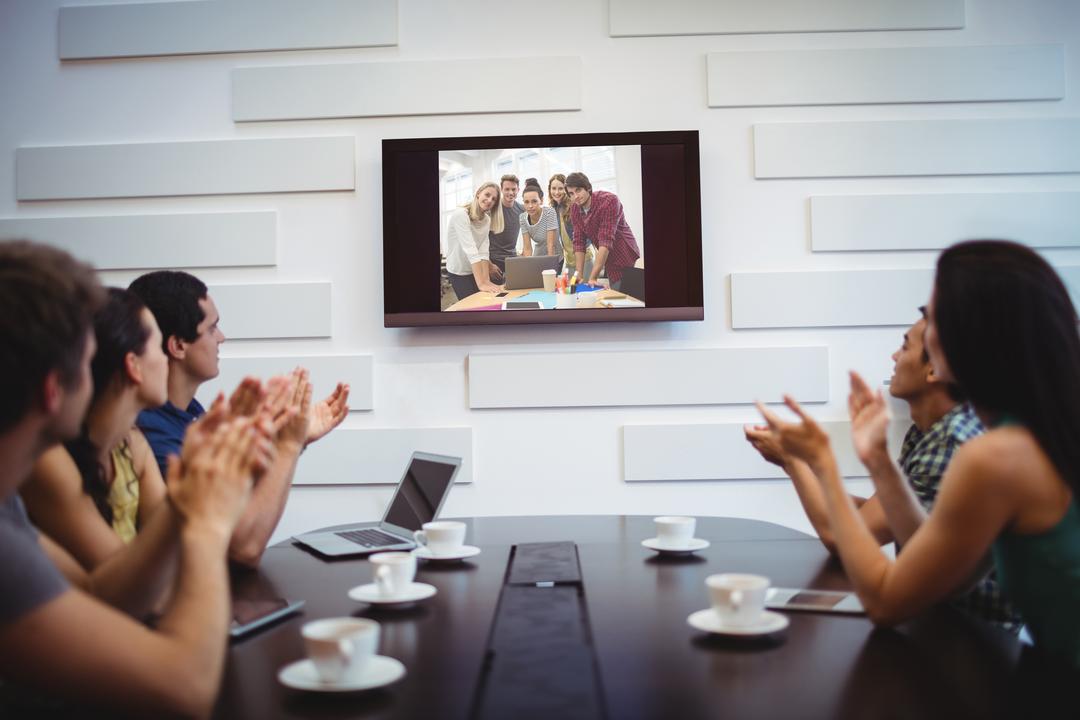 Image of a Group of People Applauding During a Meeting for Another Group in the Video Conference