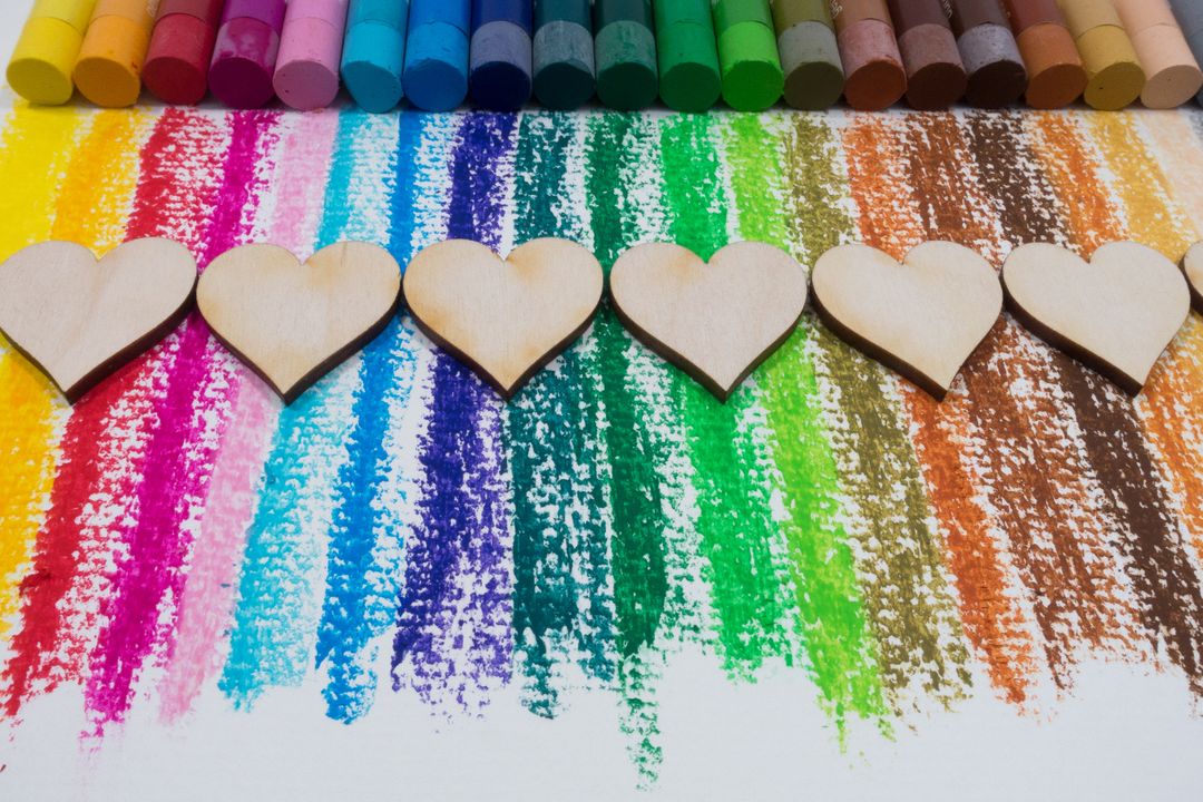 Image of colorful crayons with wooden hearts