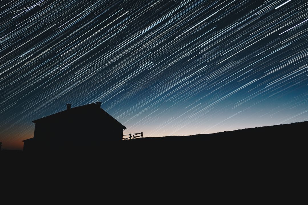 a star trail over a house - Free Images, Stock Photos and Pictures on Pikwizard.com