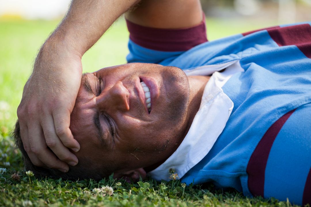 Injured rugby player with eyes closed lying on field - Free Images, Stock Photos and Pictures on Pikwizard.com