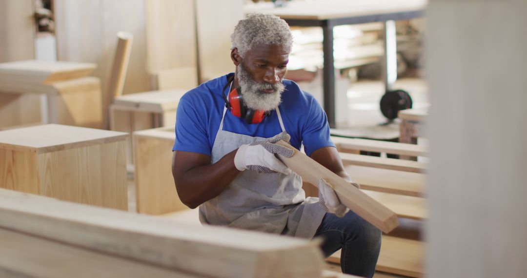 Young carpenter african american man looking and choosing wood and